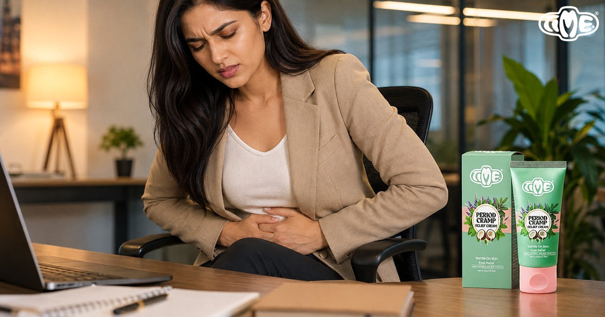 Woman at office desk experiencing period cramps, with TIME Period Cramp Relief Cream tube and box displayed beside her laptop
