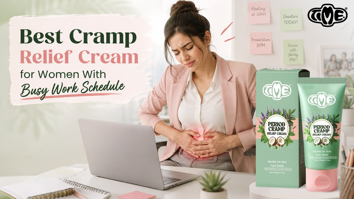 Woman in a pink blazer holding her abdomen in pain while working at a laptop, with TIME Period Cramp Relief Cream products displayed — Best Cramp Relief Cream for Women With Busy Work Schedule
